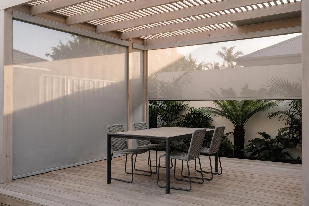 An alfresco area in use at dusk with blinds lowered