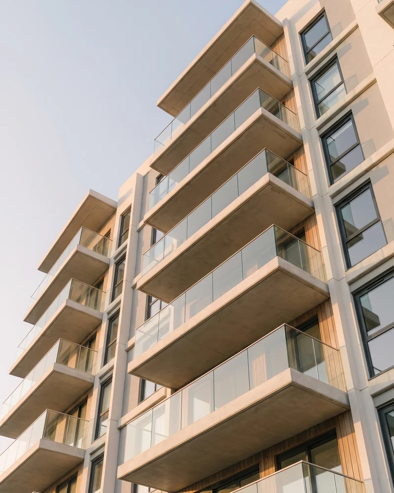 Apartment balconies stacked up a coastal high-rise tower