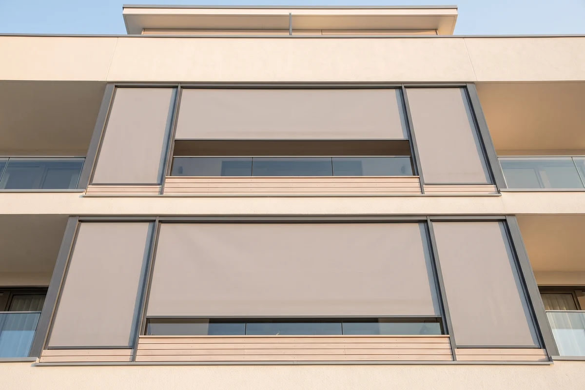 The exterior of an apartment building with a repeating run of balconies
