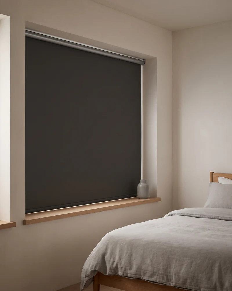 Blockout roller blind fully lowered over a bedroom window