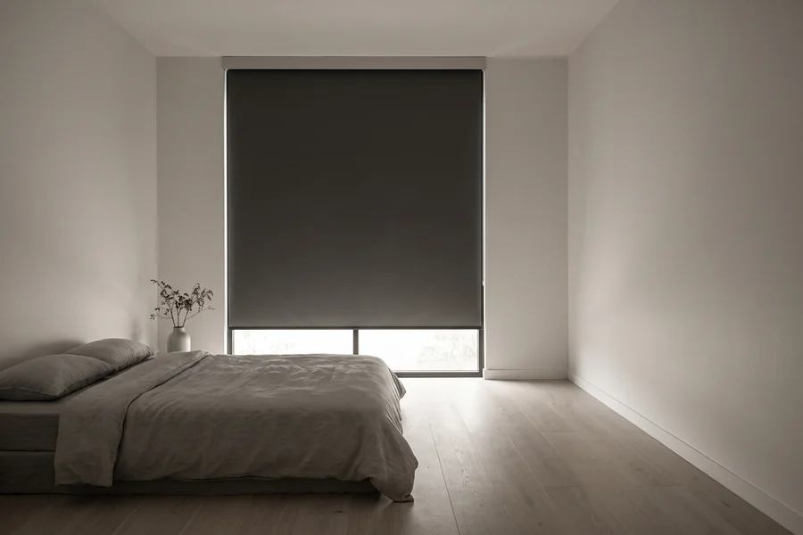Blockout roller blind lowered over a Brisbane bedroom window