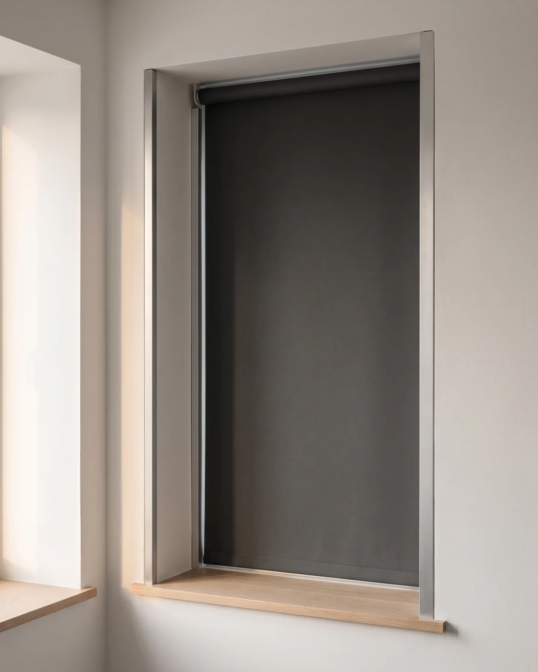Blockout roller blind fitted inside a bedroom window reveal