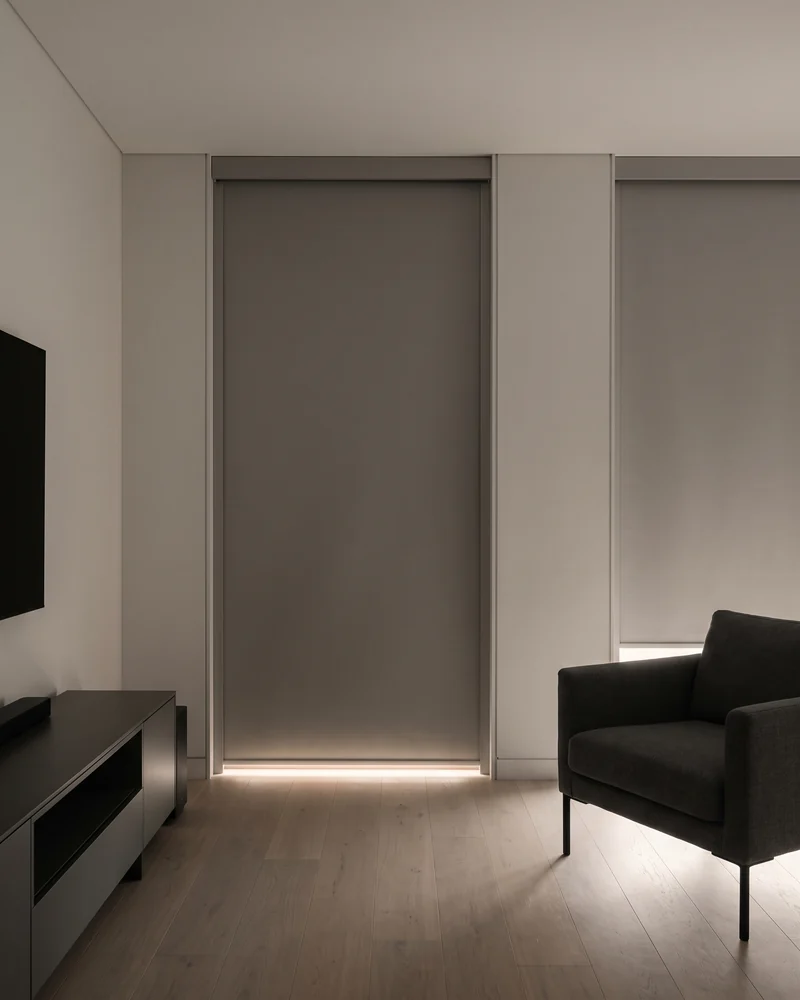 Blockout roller blinds darkening a media room