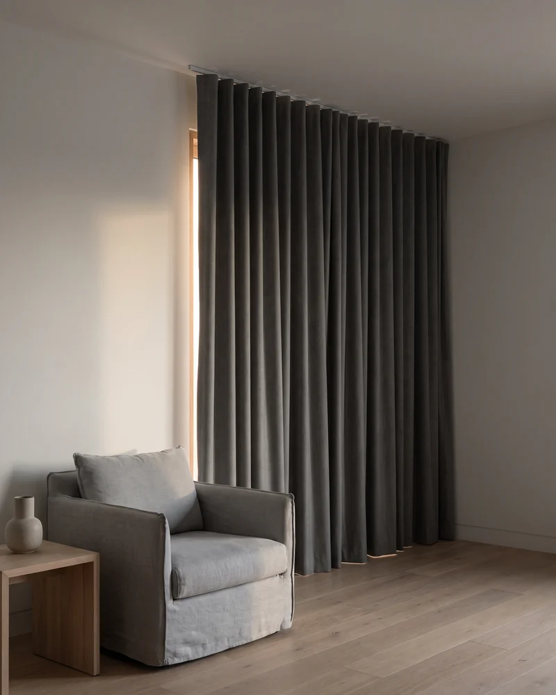 Blockout S fold curtain drawn fully closed across a bedroom window in an even wave