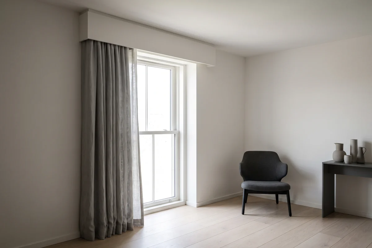 A boxed pelmet enclosing the curtain track and heading above a window