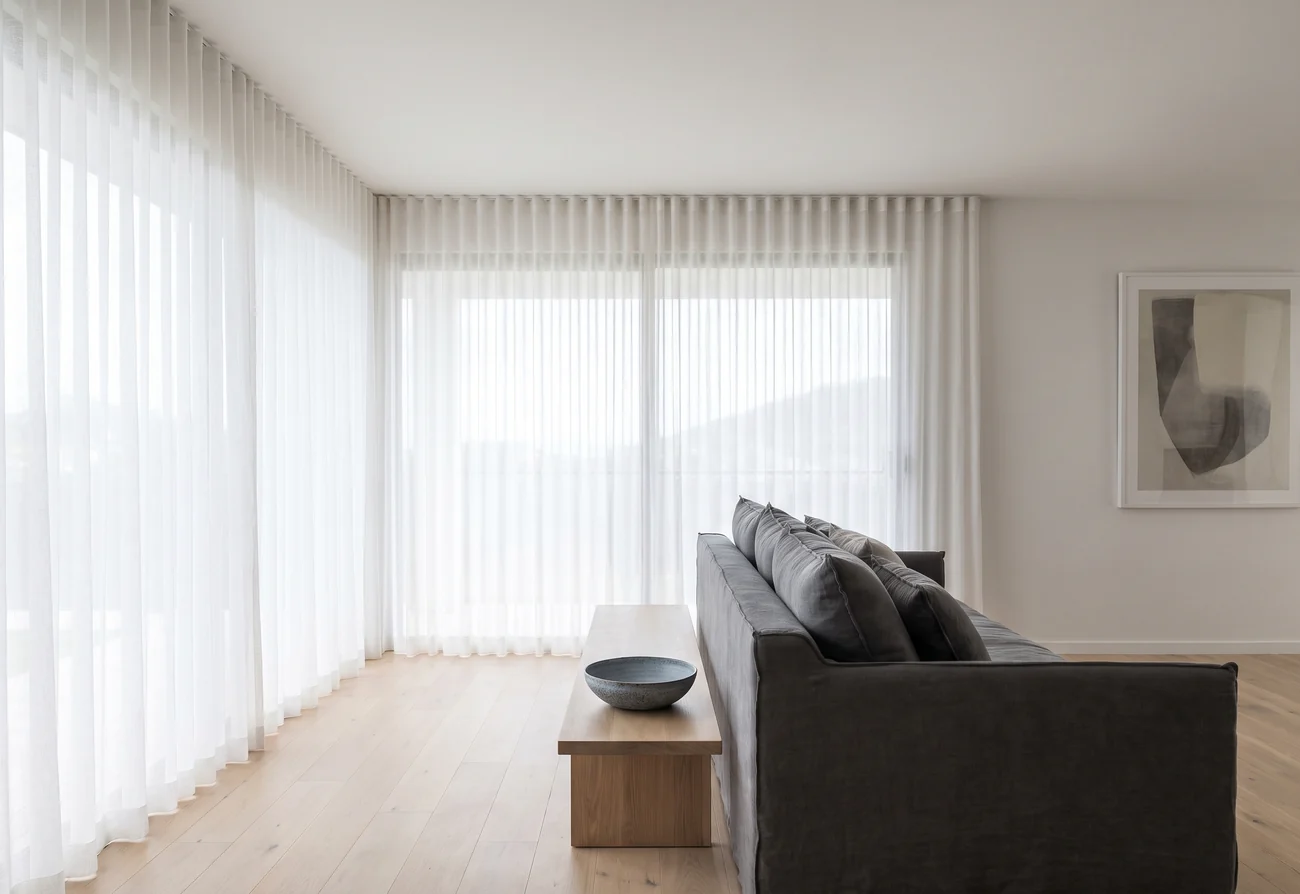 Bright open living room with full-height window treatments
