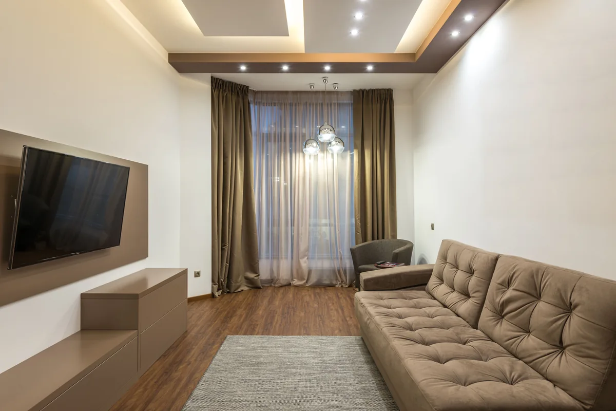 Full-length curtains hung from a ceiling-fixed track in a living room