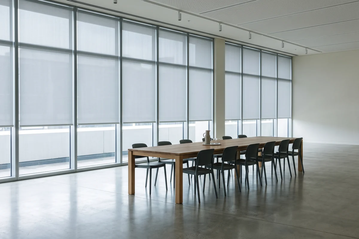 Commercial workspace with large glazed windows and roller blinds