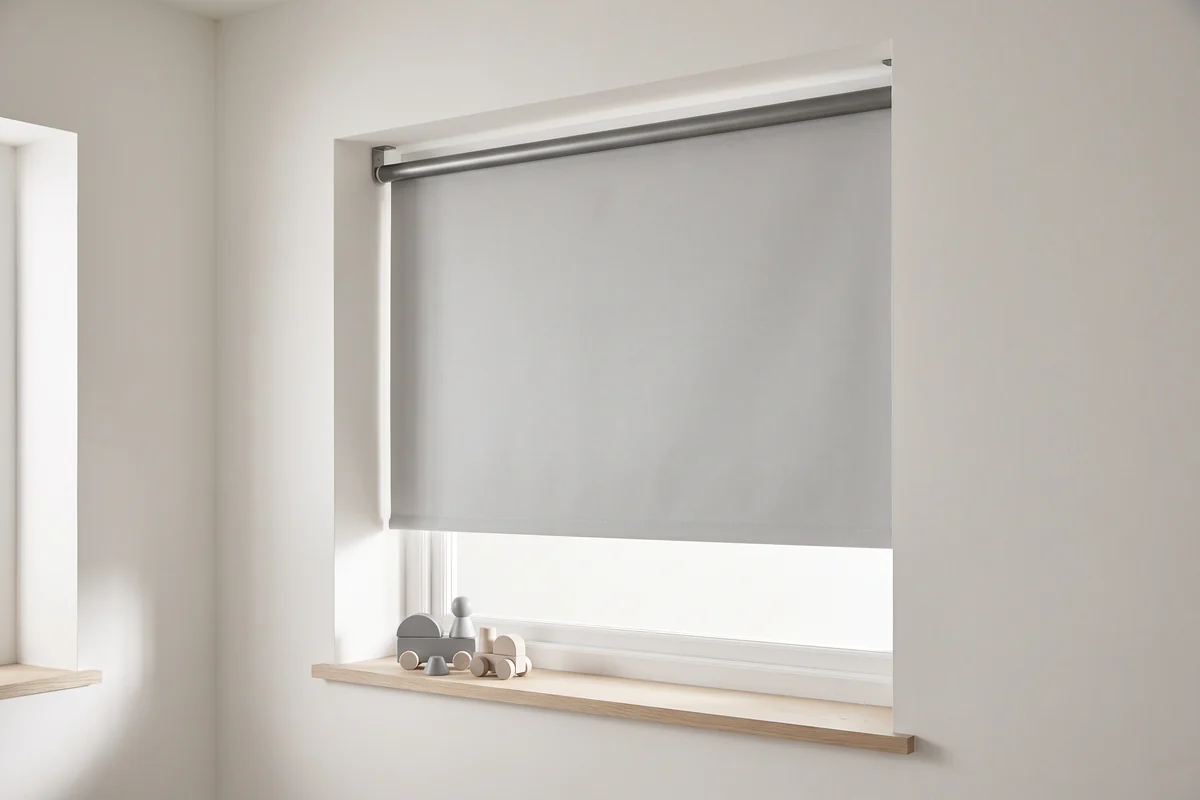 A cordless roller blind lowered over a child's bedroom window with no chain at either bracket