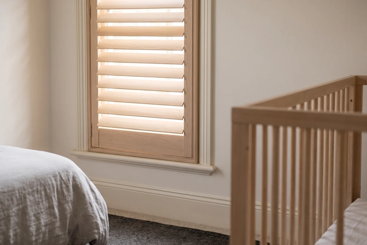 A shutter on a low window in a child's room with no cord or chain of any kind