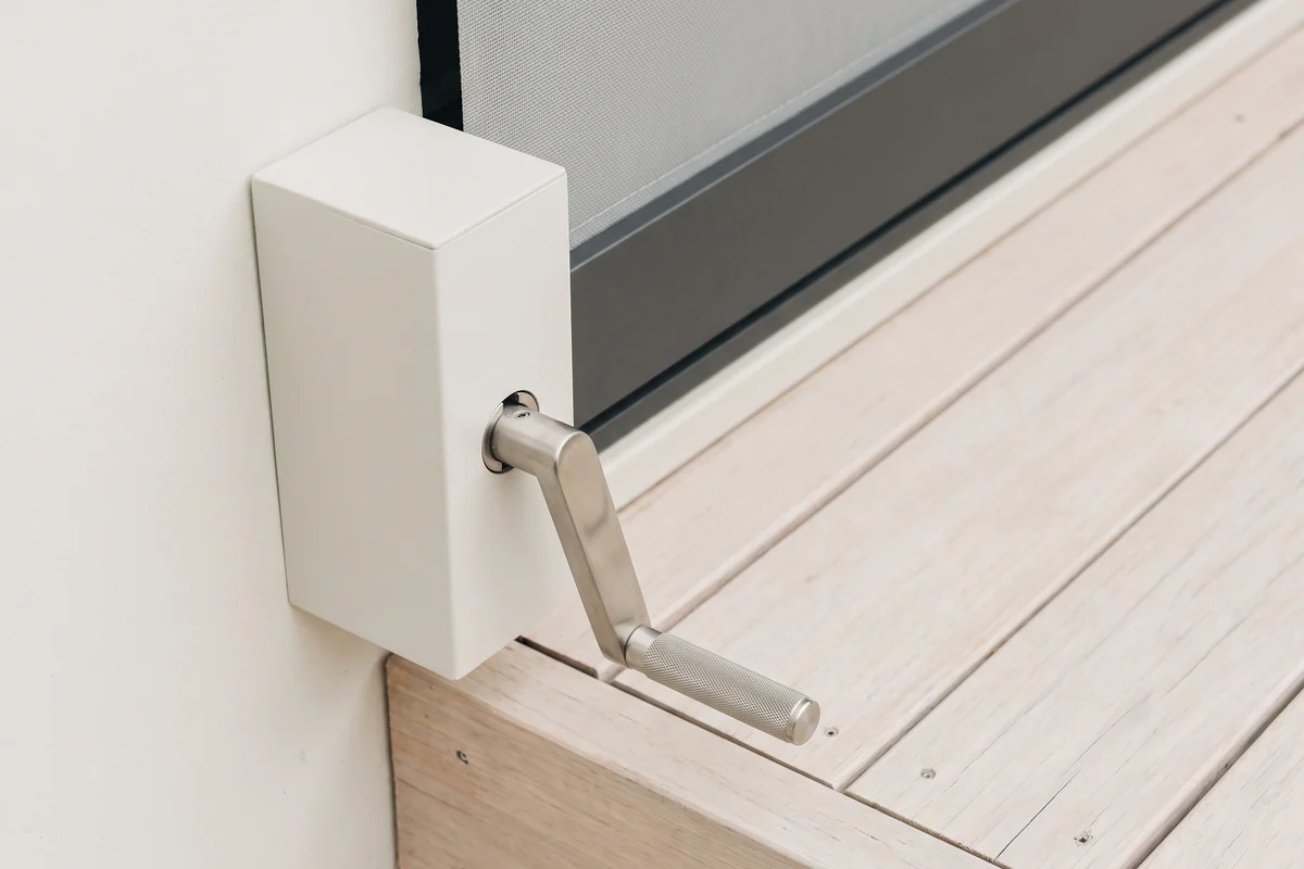 A crank handle used to operate an outdoor blind