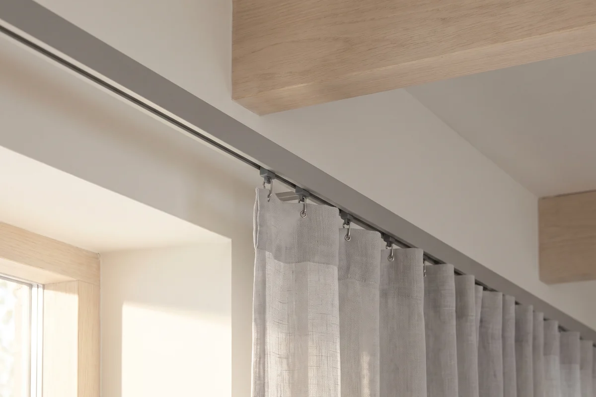 Curtain runners seated in a ceiling-fixed track