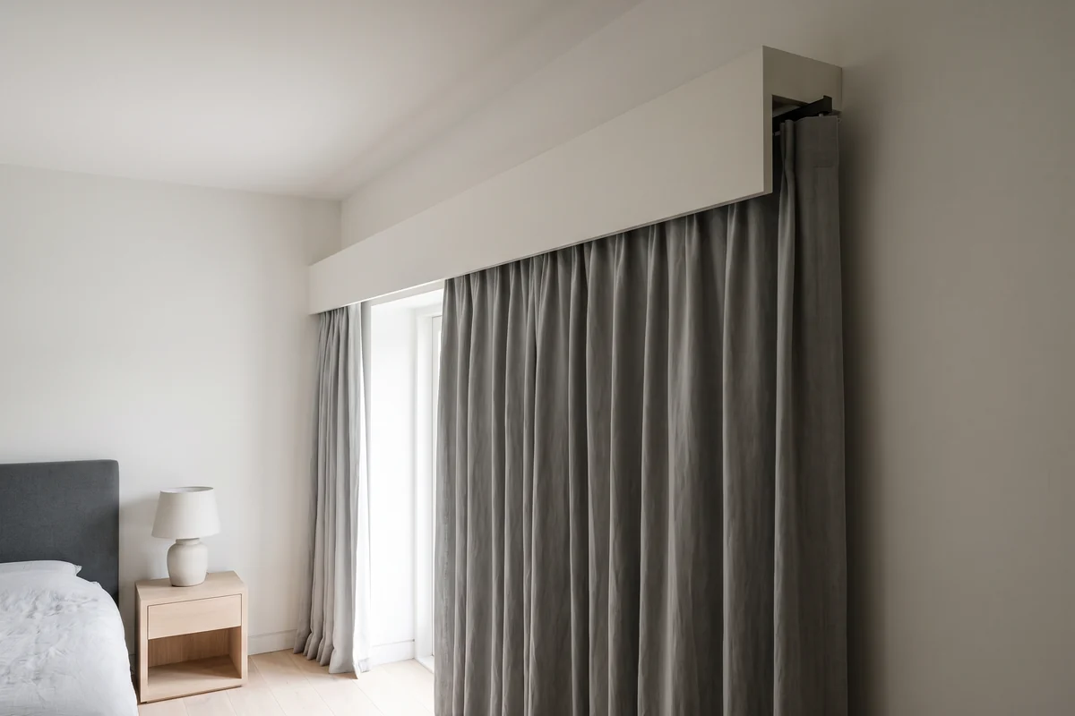 Curtain track mounted well above the window with a pelmet closing the gap at the top