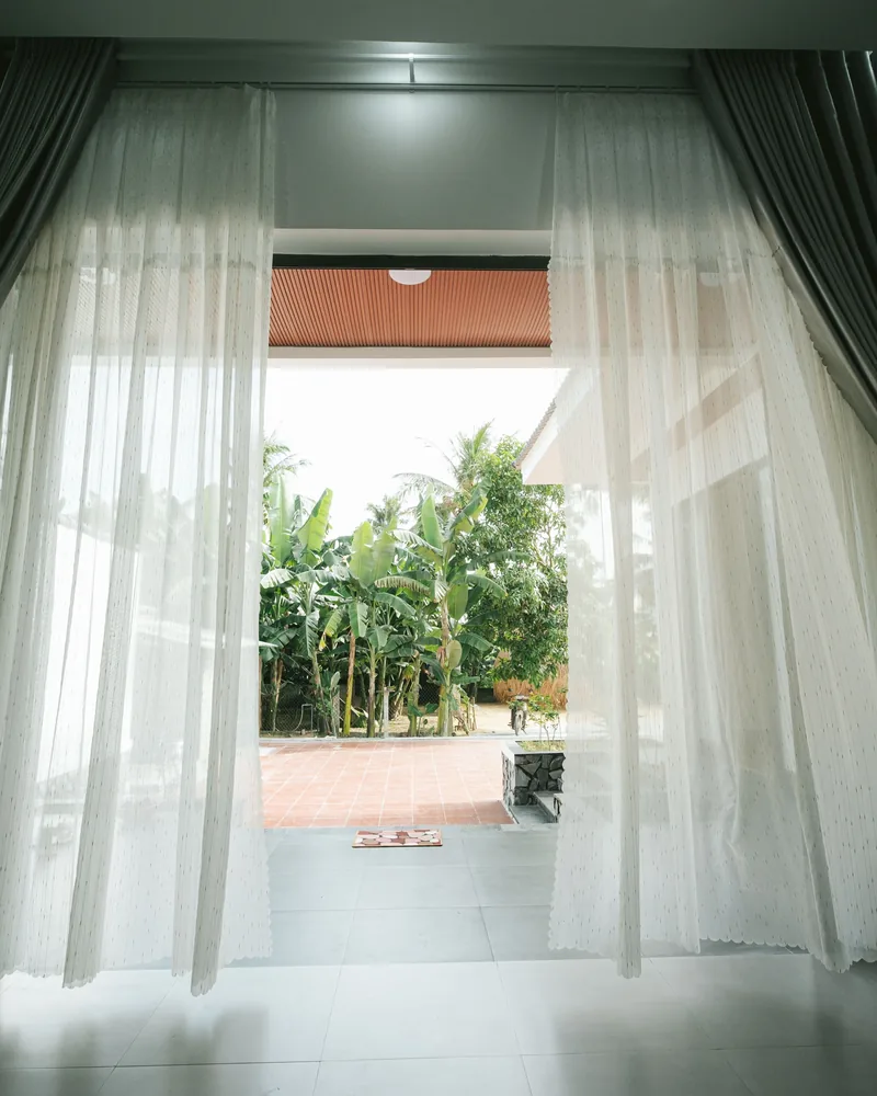 Curtains stacked beside a sliding glass door