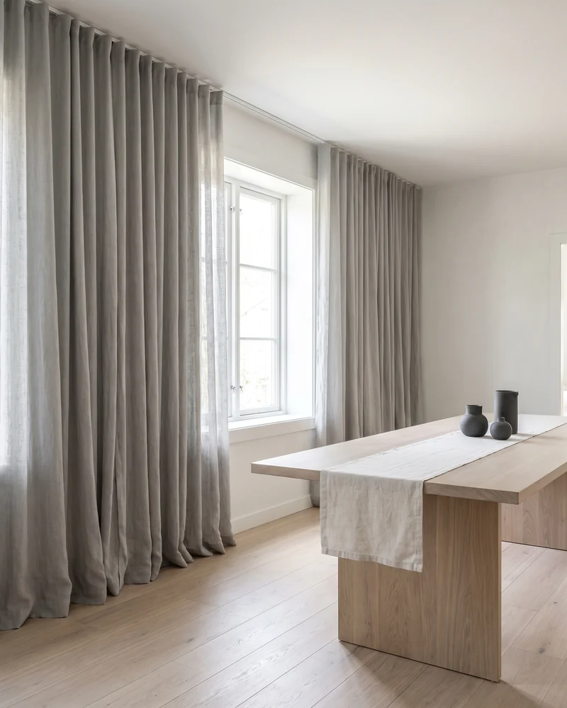 Decorative curtains framing a dining room window