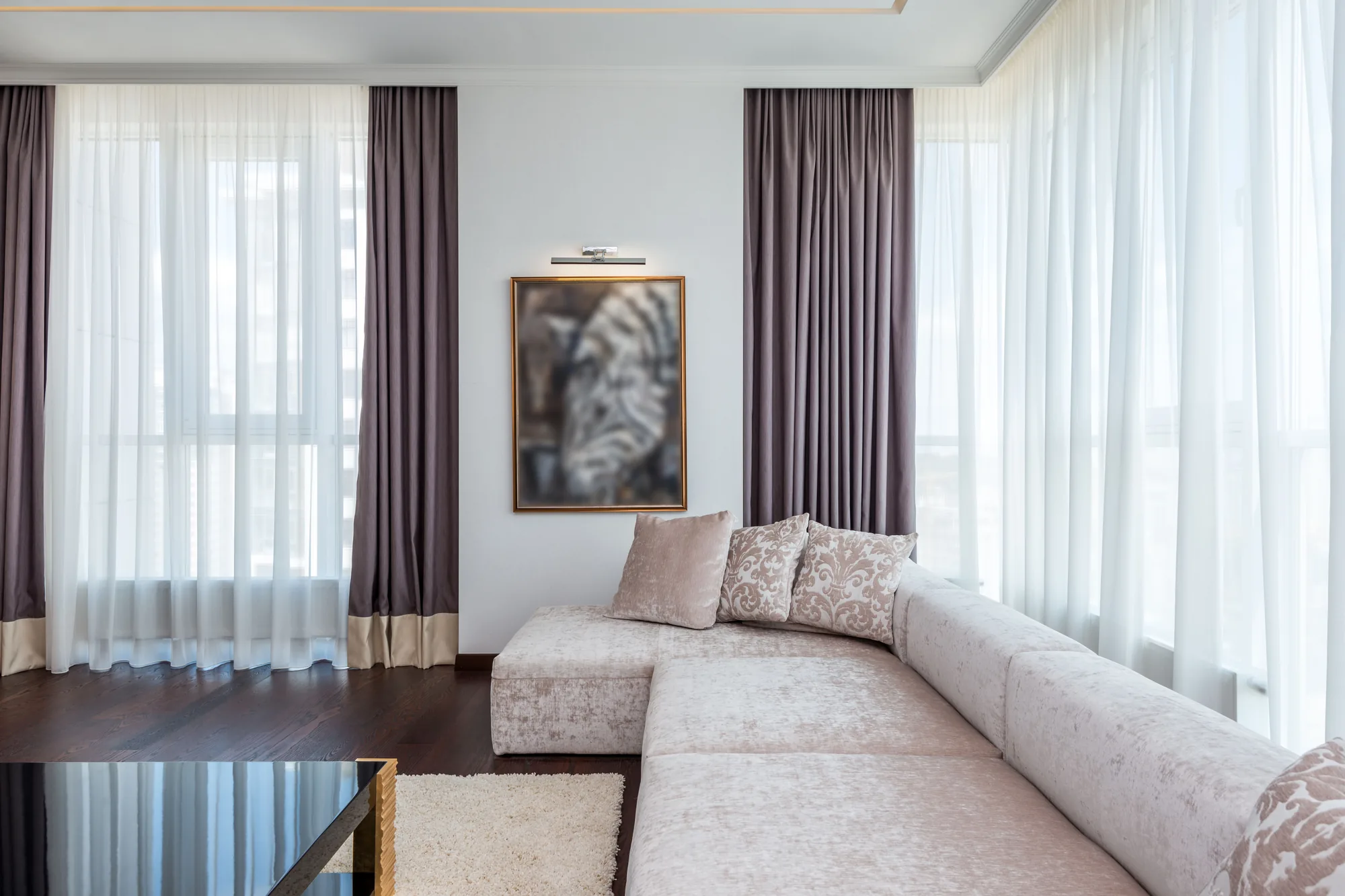 Floor-length curtains drawn back from a wide living room window