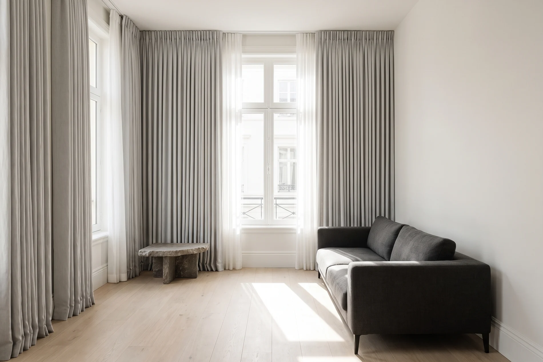 Elegant living room with full-length drapery framing tall windows