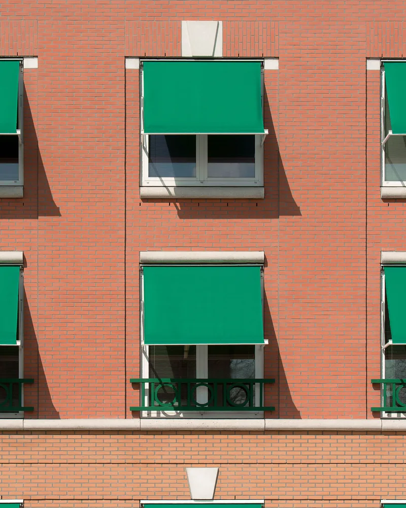 A fixed awning shading a window from above
