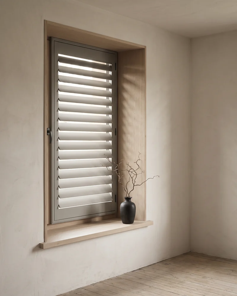A fixed shutter panel set into a window reveal