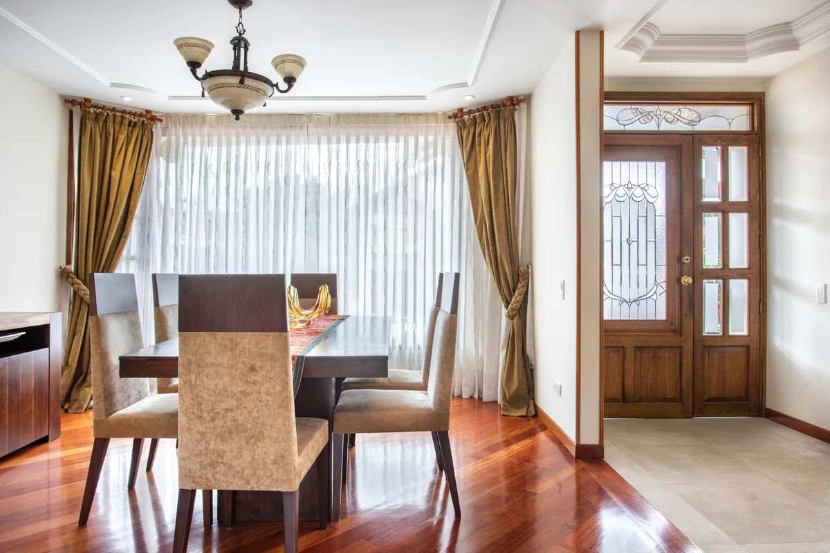 Full-height curtains running to the floor beside tall windows