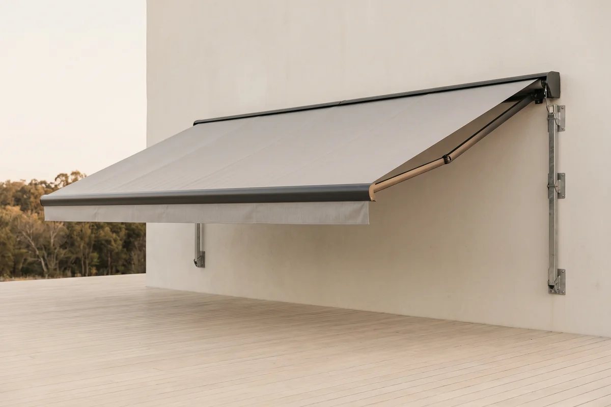 An extended folding arm awning under wind load, its front bar carried only by the cantilevered arms