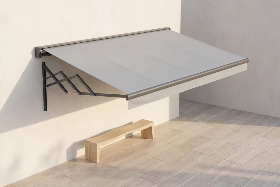 A folding arm awning extended over a paved courtyard