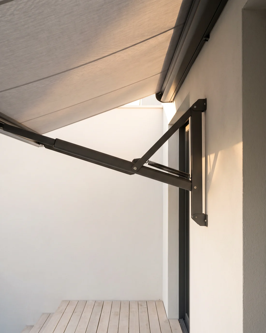 Retractable awning shading a terrace on a bright afternoon