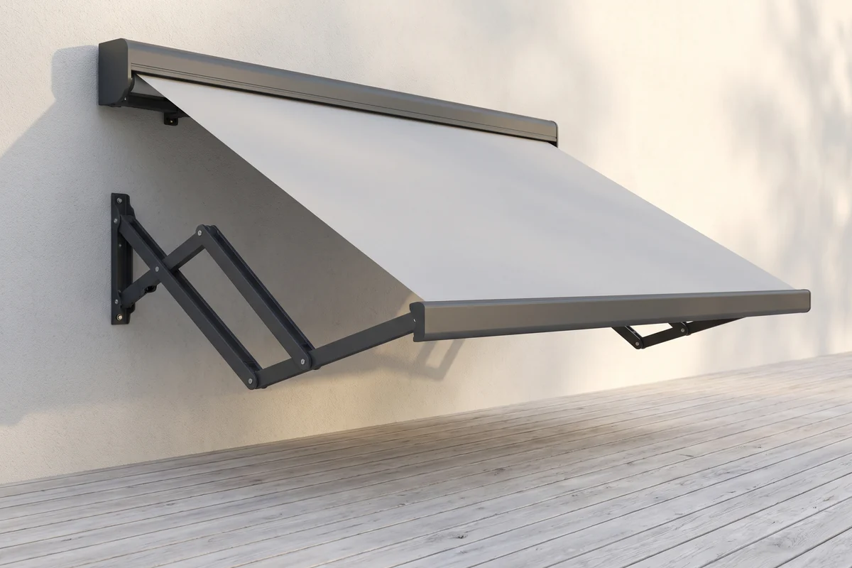 A folding arm awning part extended, one arm bent at the elbow under the fabric