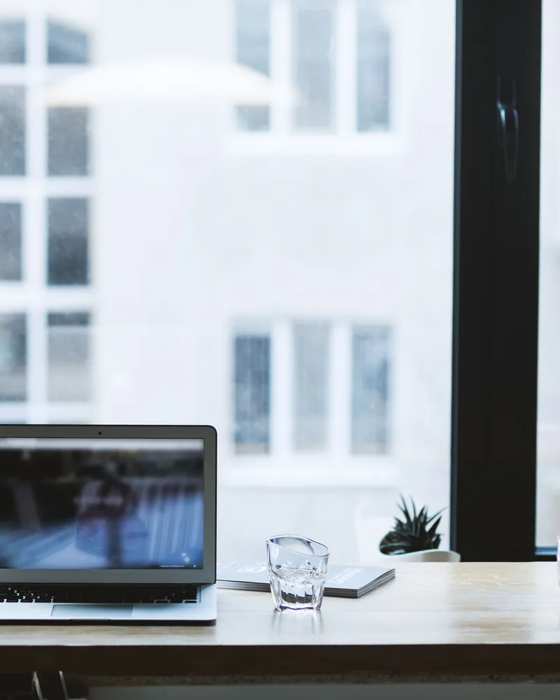 A desk set beside a window in a home office