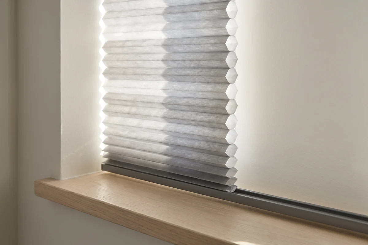 The louvres of a white polymer shutter angled part open