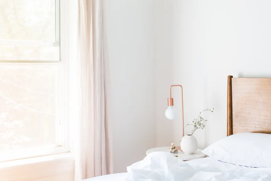 Linen curtains hanging beside a living room window