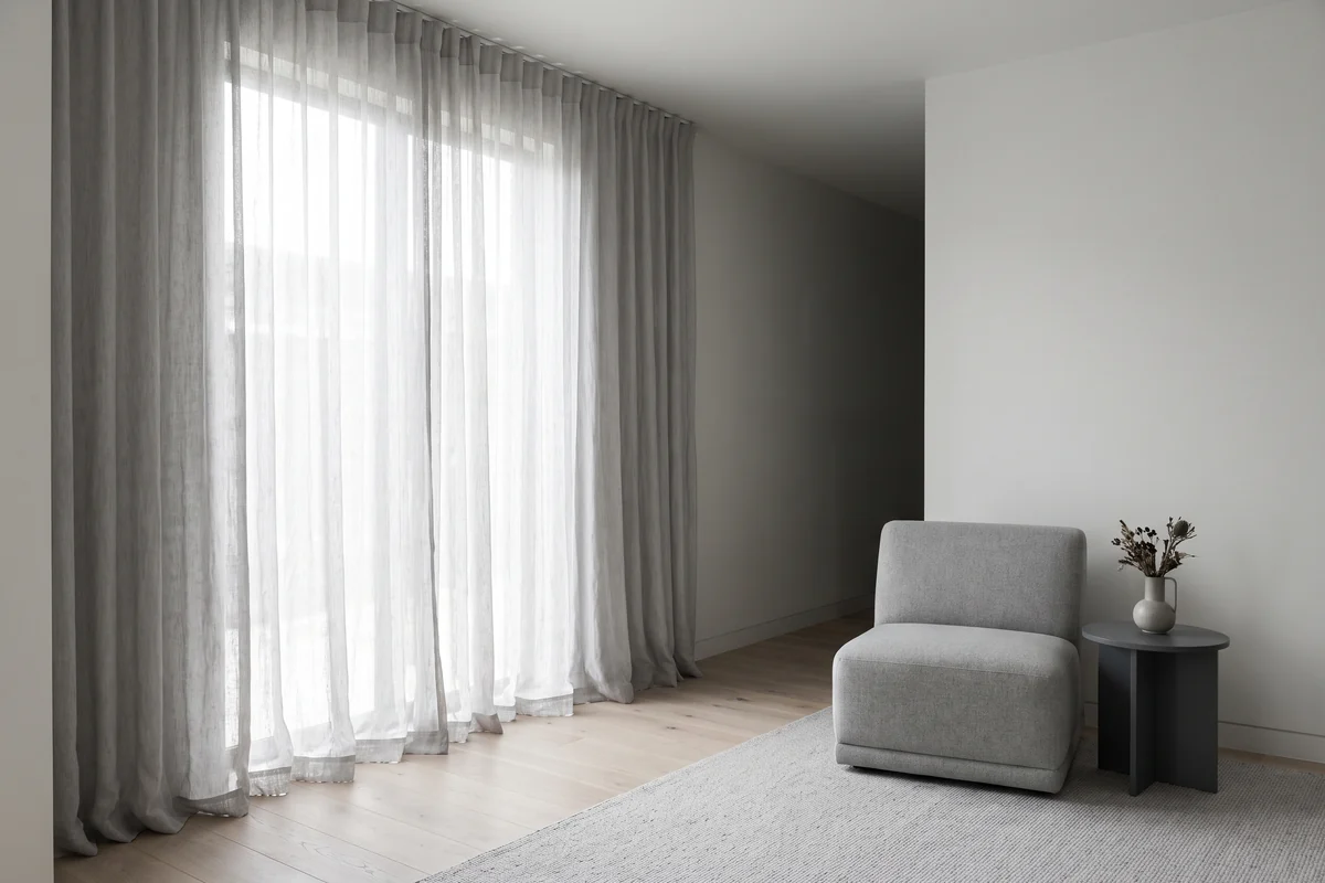 Living room window with curtains running full length from ceiling to floor