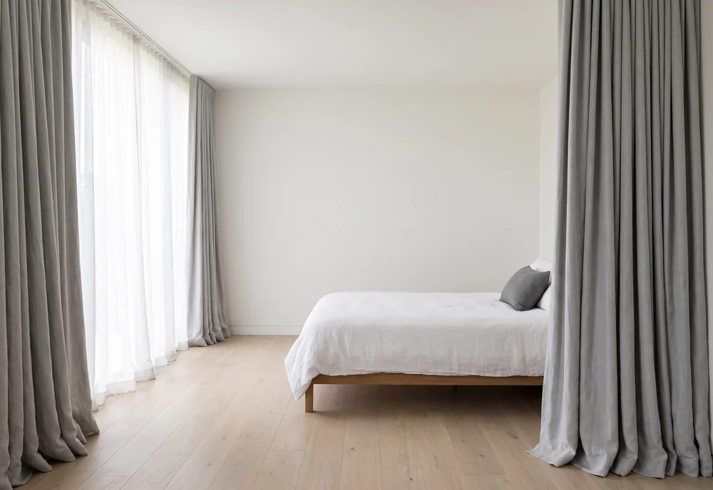 Calm bedroom with layered curtains and sheers