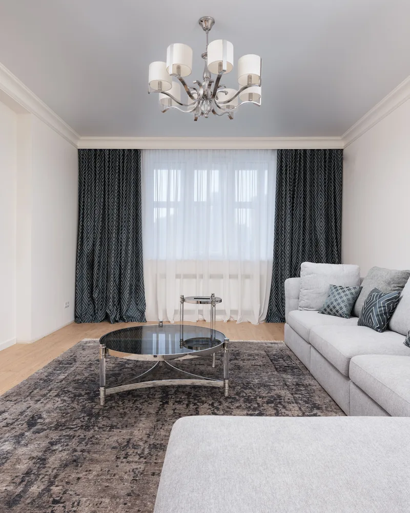 Floor-to-ceiling curtains in a newly finished minimalist living room