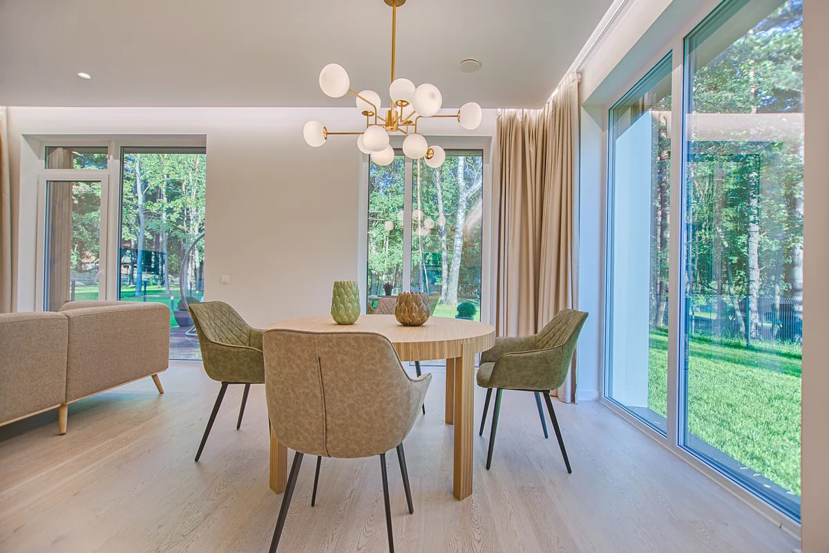Curtains stacked open to one side of a wide sliding glass door