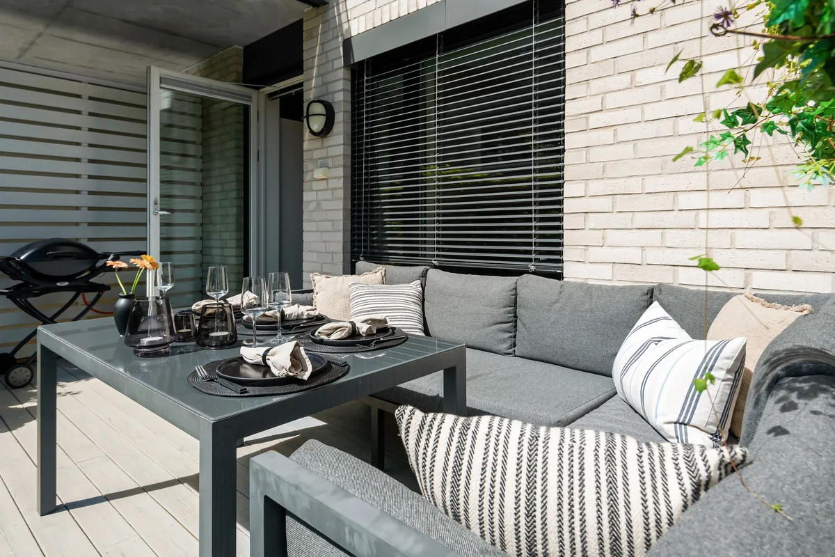 Outdoor blinds lowered across a covered patio