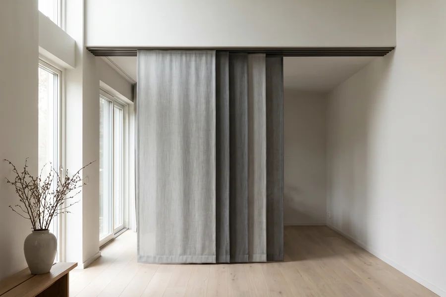 Wide flat fabric panels on a multi-channel track across a sliding door