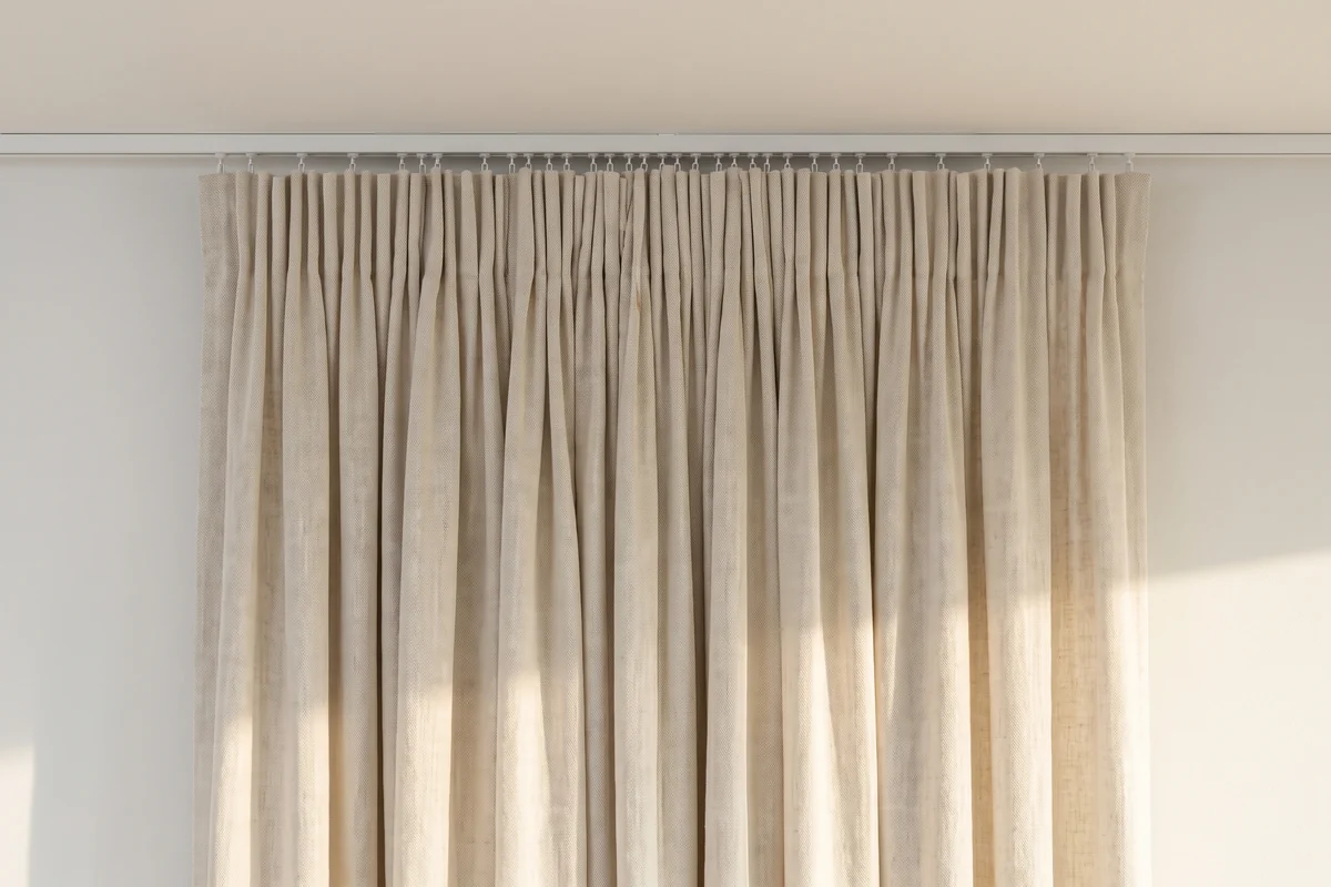 A pencil pleat curtain heading gathered into narrow, evenly packed folds along a heading tape