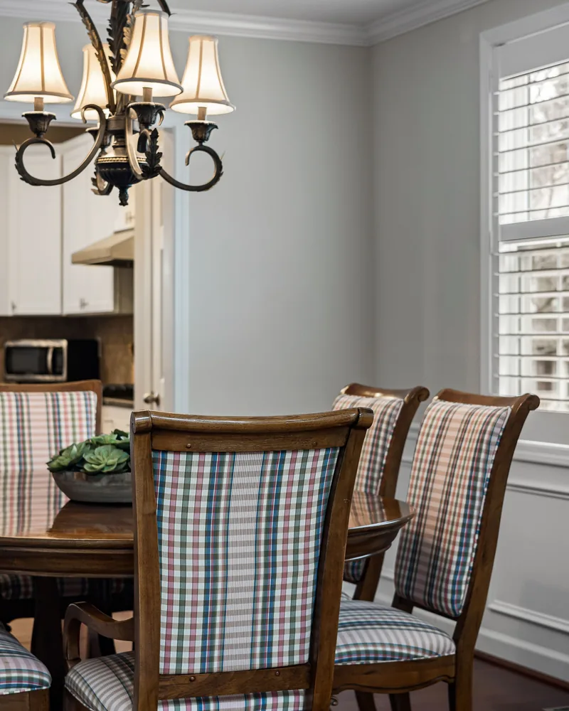 A shuttered window in a dining room beside the kitchen