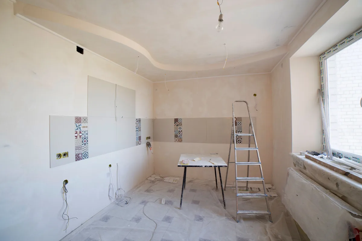 Ceiling and wall junction above a window in a partly finished room