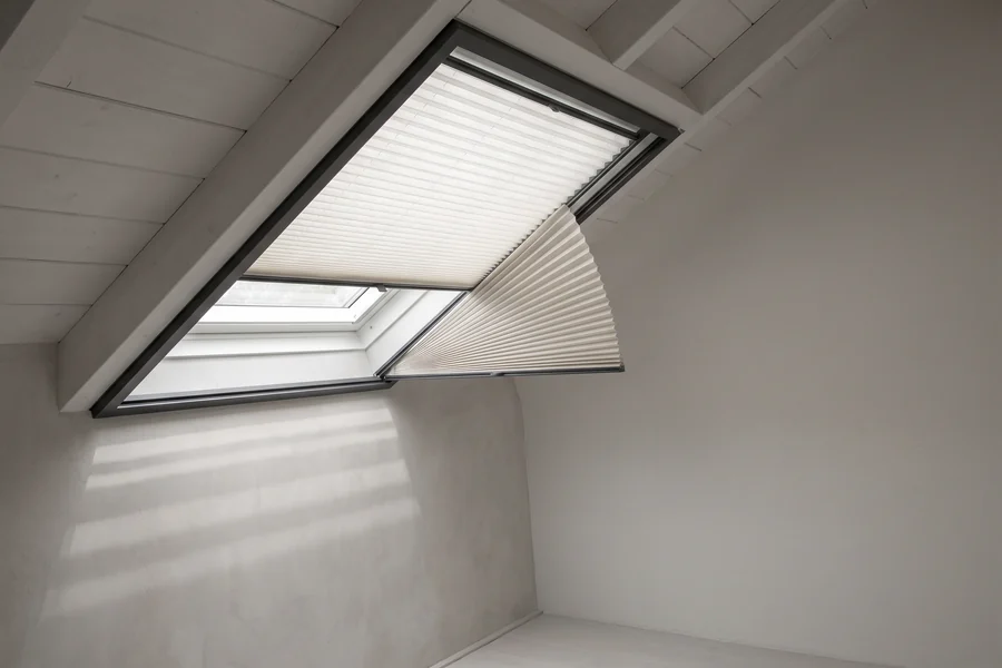 A pleated blind fitted to an angled window under a sloping ceiling