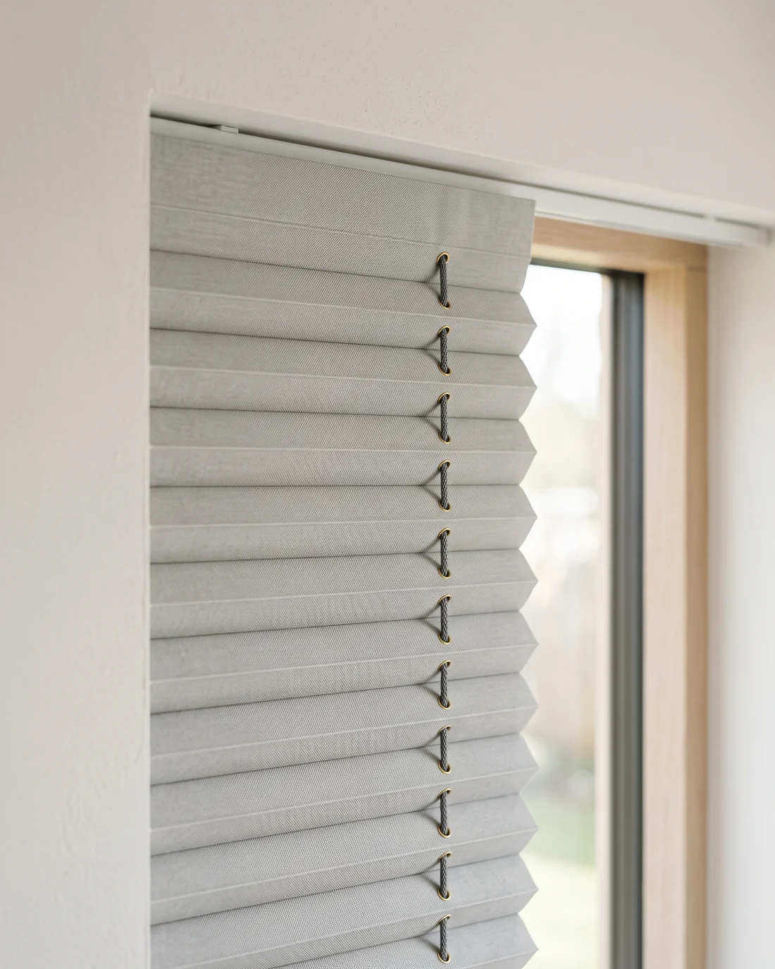 Close detail of the crisp folds in pleated blind fabric