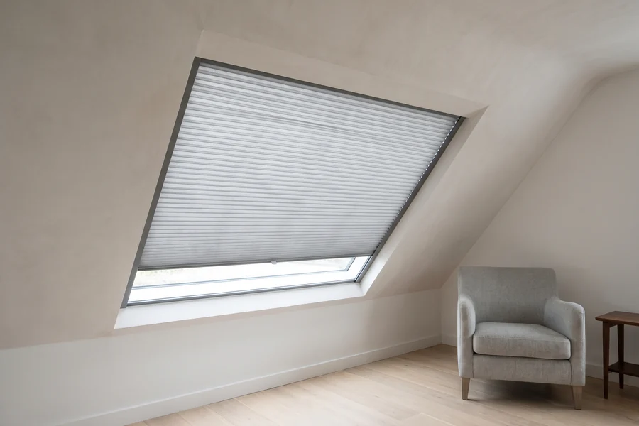 A pleated blind fitted flush in an angled window under a sloping ceiling