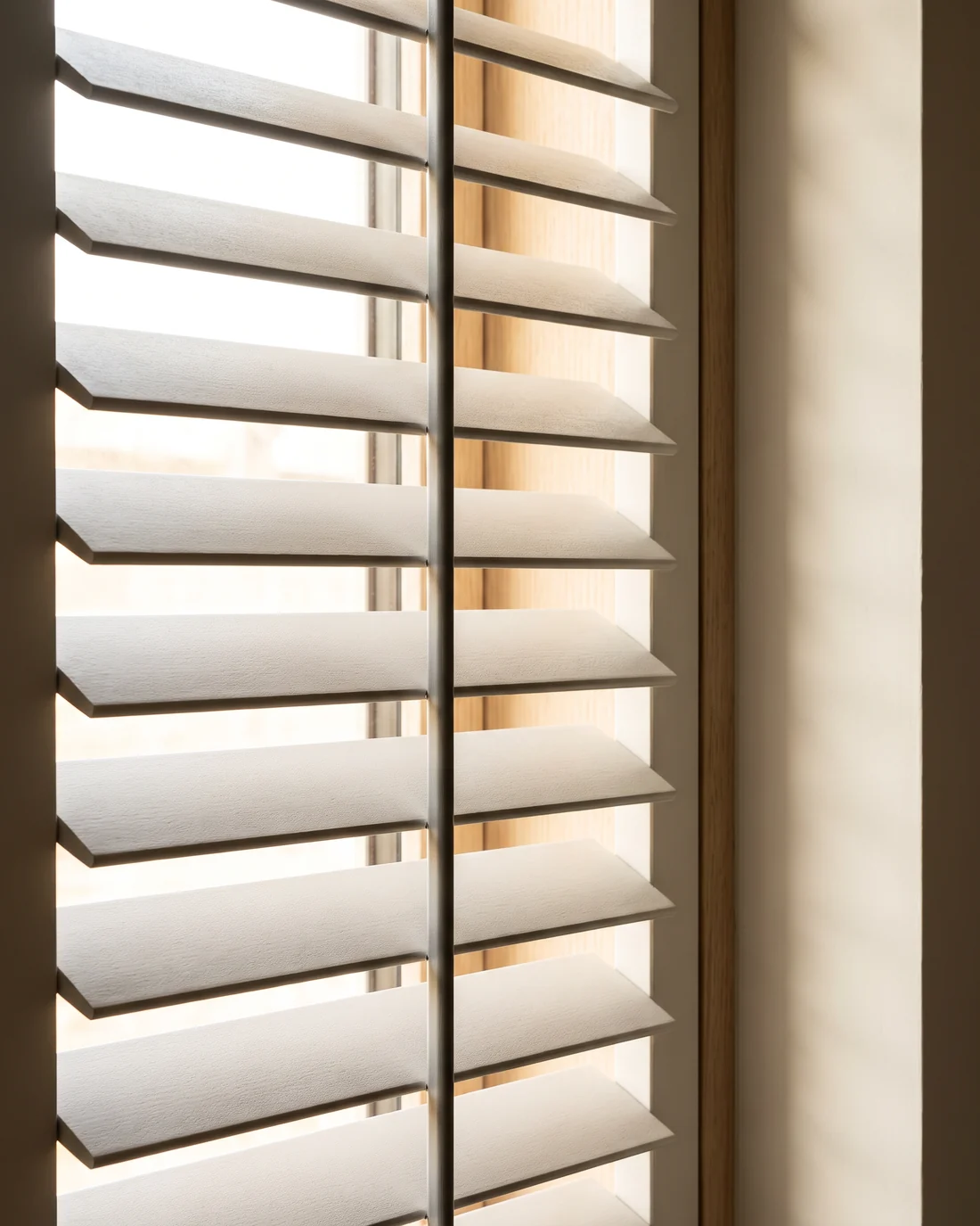 Close detail of polymer shutter louvres angled against daylight