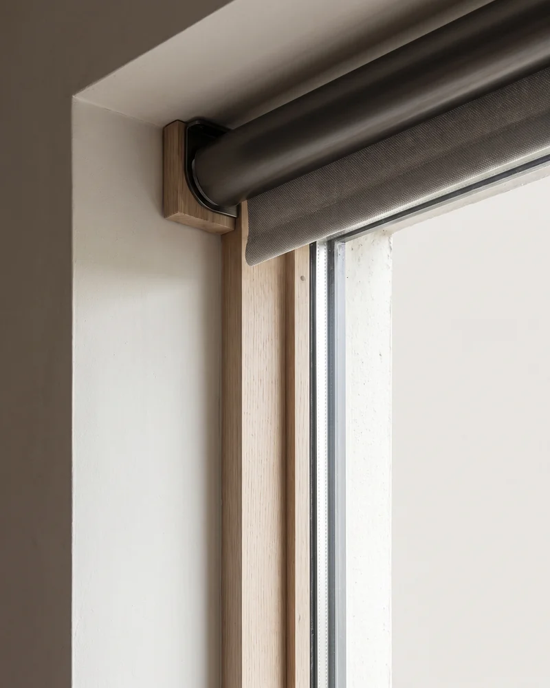 Back-rolled blind sitting close to the window glass