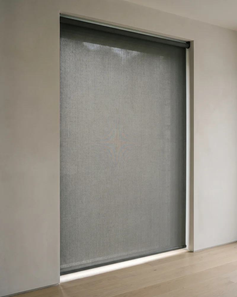 A roller blind lowered across a living-room window