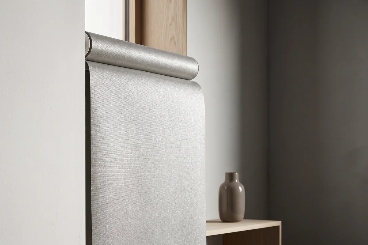 The reflective metallised backing on the reverse of a roller blind fabric