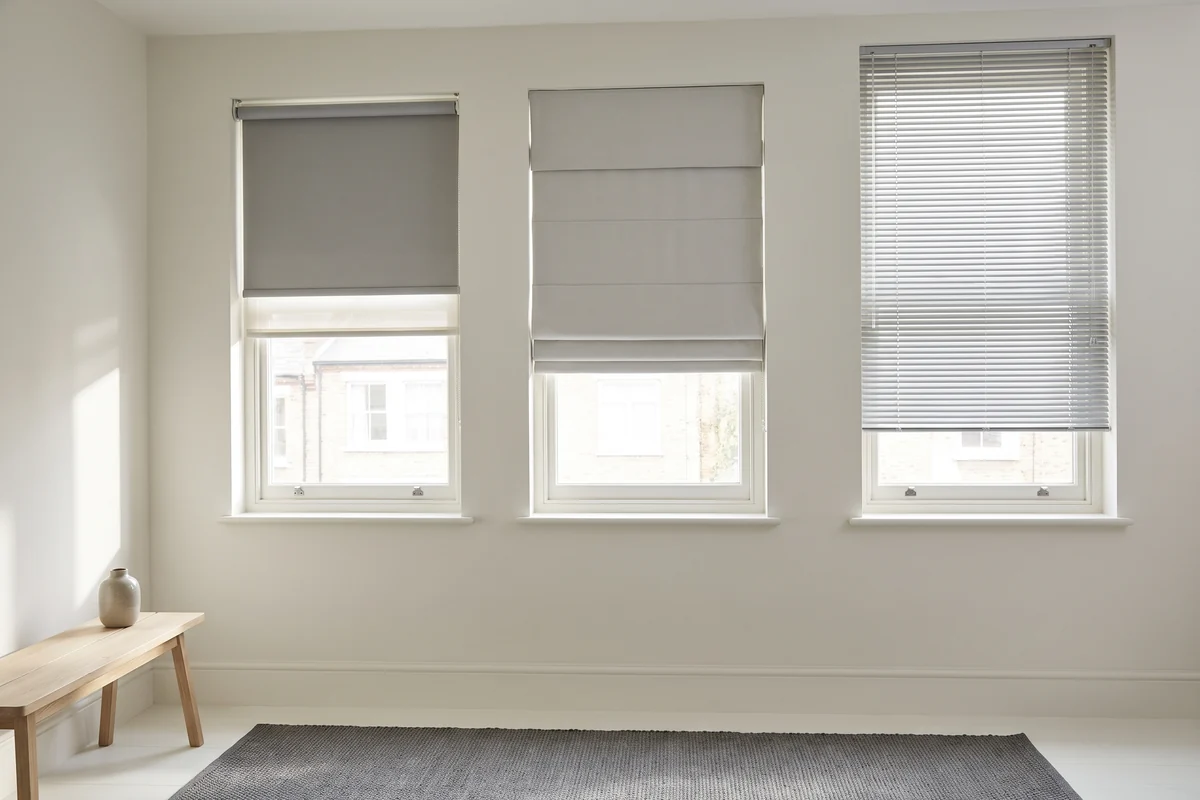 Different blind types fitted at adjacent windows in one room