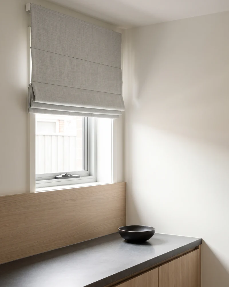 A Roman blind over a kitchen window