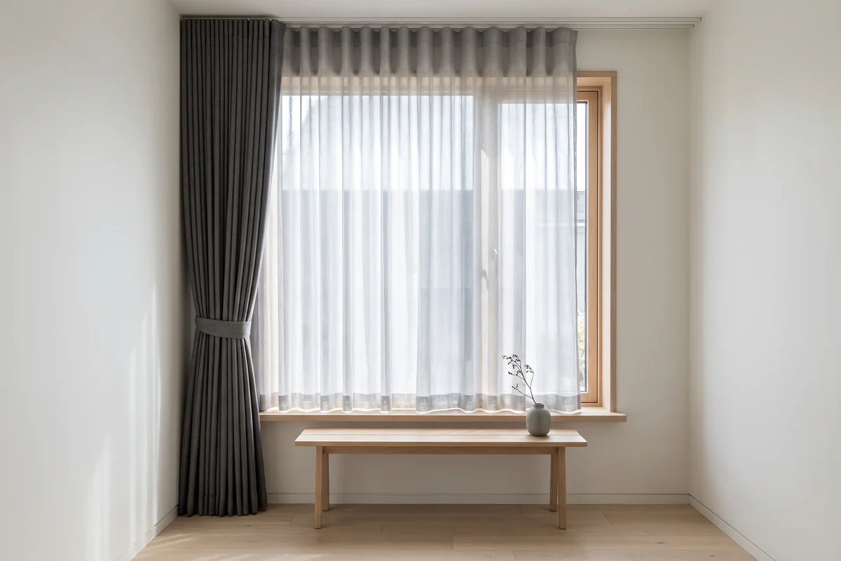 A sheer curtain layered with a blockout curtain at one window